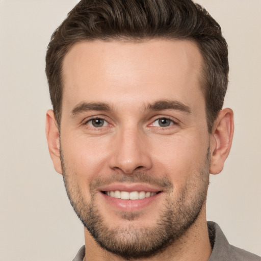 Joyful white young-adult male with short  brown hair and brown eyes