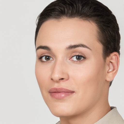 Joyful white young-adult female with short  brown hair and brown eyes