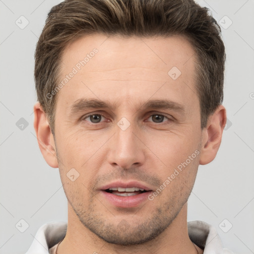 Joyful white young-adult male with short  brown hair and brown eyes