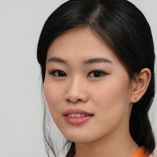 Joyful asian young-adult female with medium  black hair and brown eyes