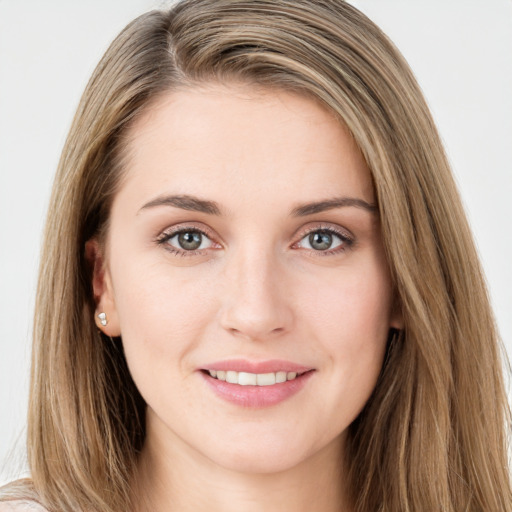 Joyful white young-adult female with long  brown hair and green eyes