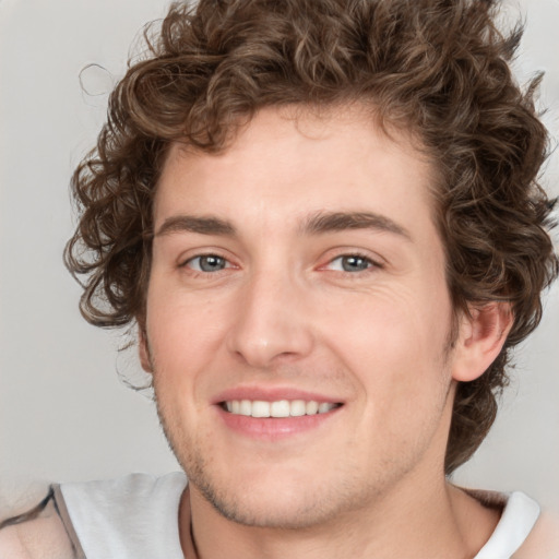 Joyful white young-adult male with medium  brown hair and brown eyes