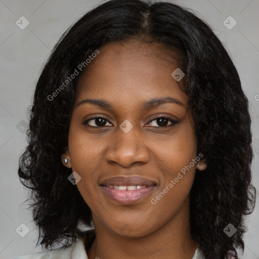 Joyful black young-adult female with long  black hair and brown eyes