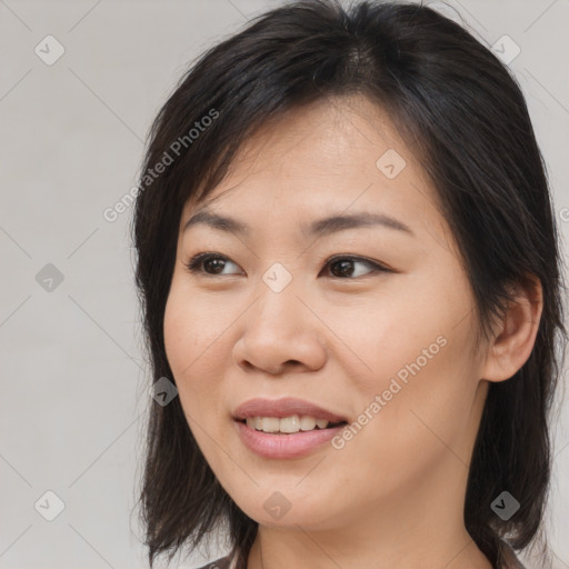 Joyful asian young-adult female with medium  brown hair and brown eyes