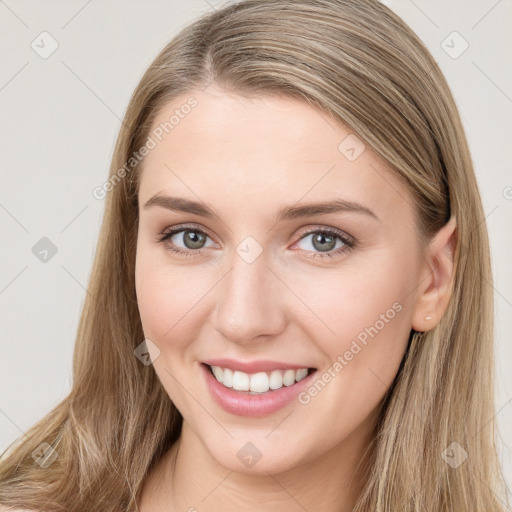 Joyful white young-adult female with long  brown hair and grey eyes