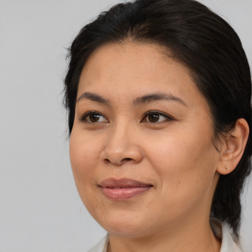 Joyful asian adult female with medium  brown hair and brown eyes