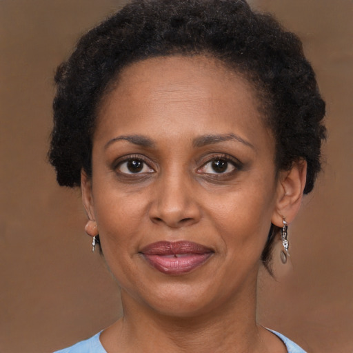 Joyful black adult female with short  brown hair and brown eyes