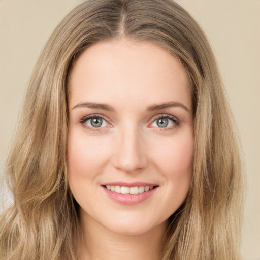 Joyful white young-adult female with long  brown hair and green eyes