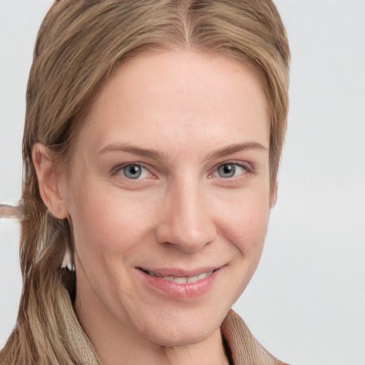 Joyful white young-adult female with long  brown hair and blue eyes