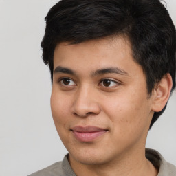 Joyful latino young-adult male with short  brown hair and brown eyes