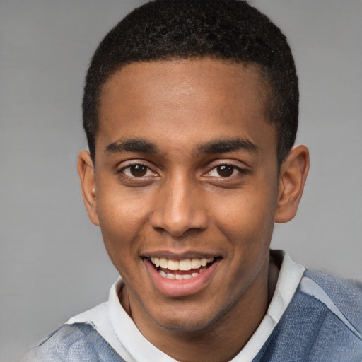 Joyful black young-adult male with short  brown hair and brown eyes