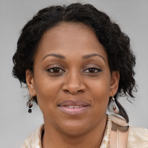 Joyful black adult female with medium  brown hair and brown eyes