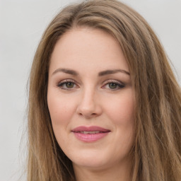 Joyful white young-adult female with long  brown hair and green eyes