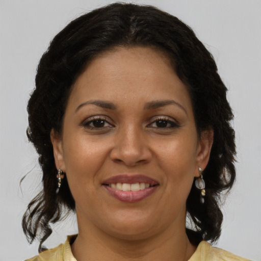 Joyful latino adult female with medium  brown hair and brown eyes