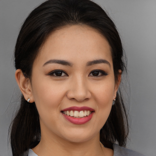 Joyful white young-adult female with long  brown hair and brown eyes