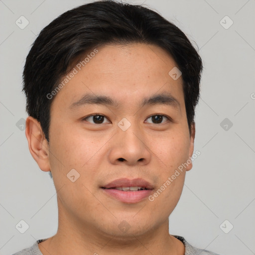 Joyful asian young-adult male with short  brown hair and brown eyes