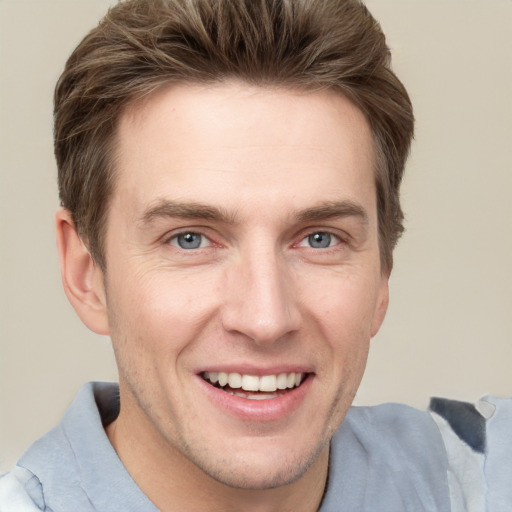 Joyful white adult male with short  brown hair and grey eyes