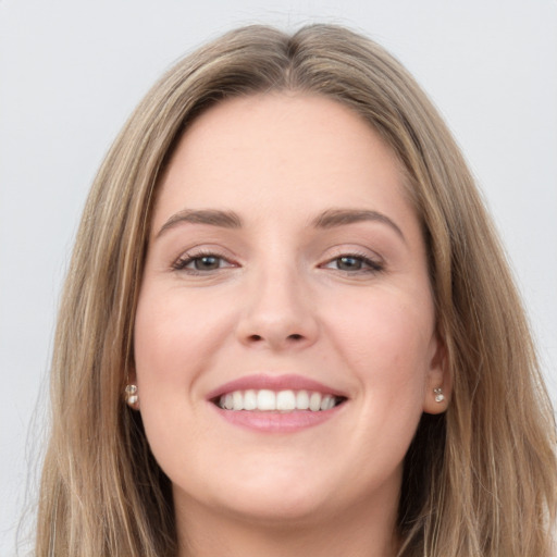 Joyful white young-adult female with long  brown hair and grey eyes