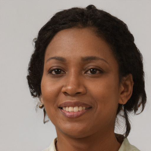 Joyful black young-adult female with medium  brown hair and brown eyes