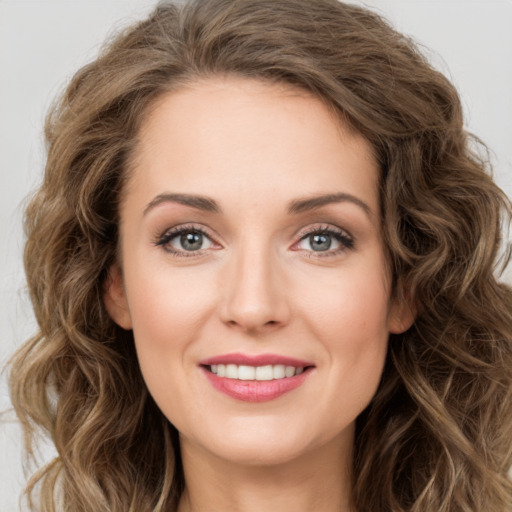 Joyful white young-adult female with long  brown hair and green eyes