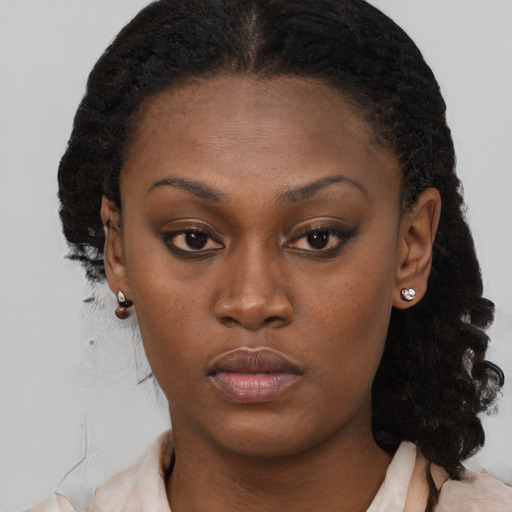 Neutral black young-adult female with medium  brown hair and brown eyes