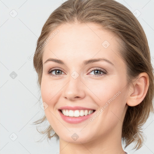 Joyful white young-adult female with medium  brown hair and blue eyes