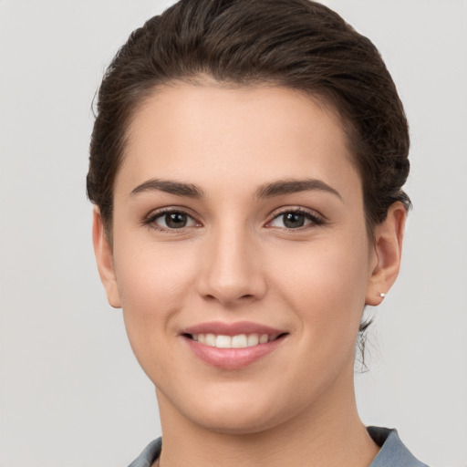 Joyful white young-adult female with short  brown hair and brown eyes