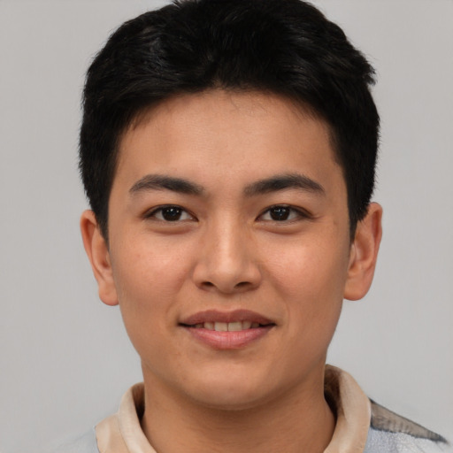 Joyful asian young-adult male with short  brown hair and brown eyes