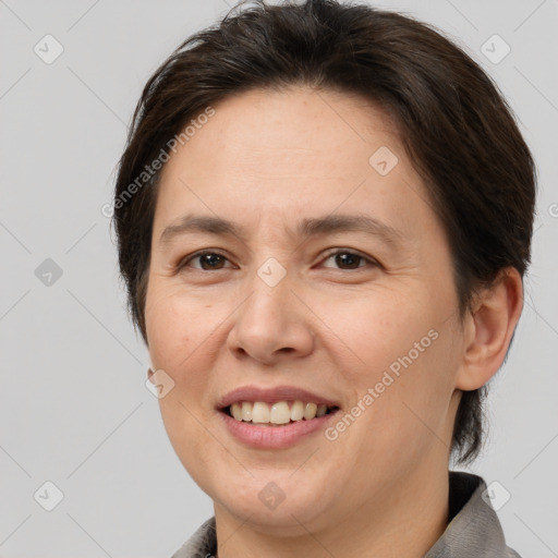 Joyful white adult female with short  brown hair and brown eyes