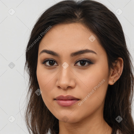 Joyful latino young-adult female with long  brown hair and brown eyes