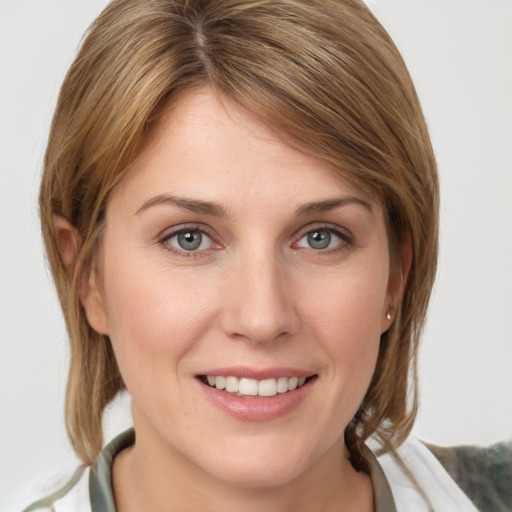 Joyful white young-adult female with medium  brown hair and grey eyes