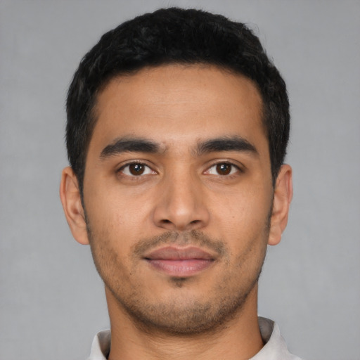 Neutral latino young-adult male with short  black hair and brown eyes