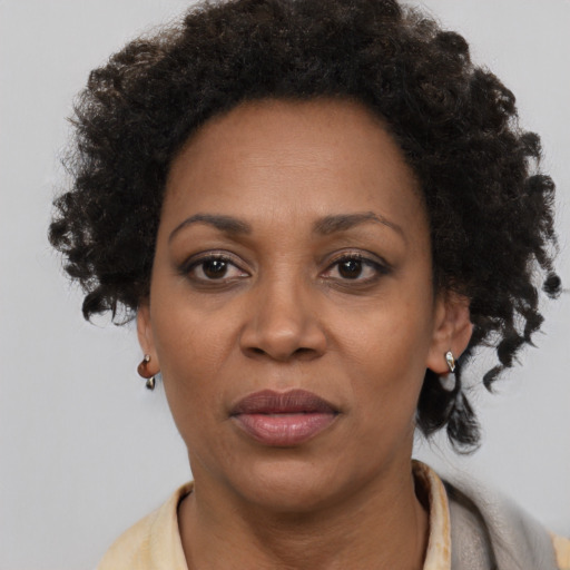 Joyful black adult female with short  brown hair and brown eyes