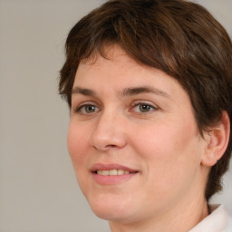 Joyful white adult female with medium  brown hair and green eyes