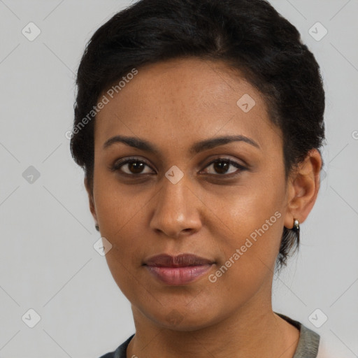 Joyful black young-adult female with short  brown hair and brown eyes