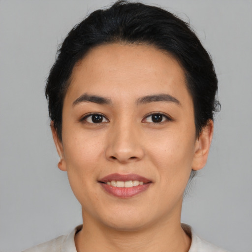 Joyful asian young-adult female with short  black hair and brown eyes