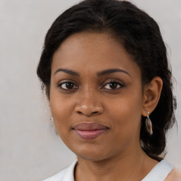 Joyful black young-adult female with medium  brown hair and brown eyes