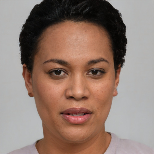Joyful latino young-adult female with short  black hair and brown eyes