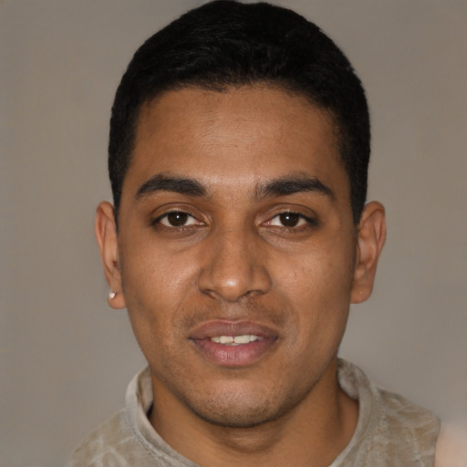 Joyful black young-adult male with short  black hair and brown eyes