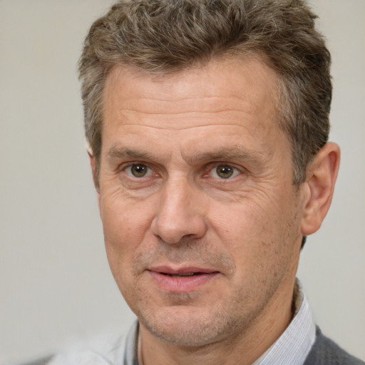 Joyful white middle-aged male with short  brown hair and brown eyes