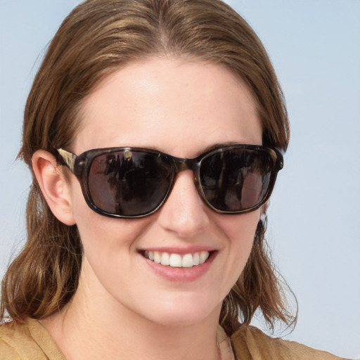 Joyful white young-adult female with medium  brown hair and blue eyes