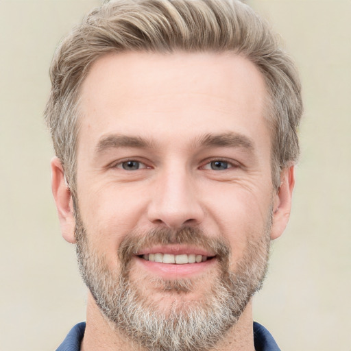 Joyful white adult male with short  brown hair and grey eyes