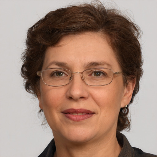 Joyful white adult female with medium  brown hair and grey eyes