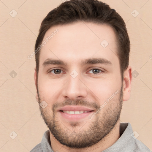 Joyful white young-adult male with short  brown hair and brown eyes