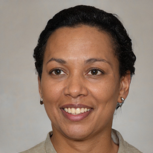 Joyful black adult female with short  black hair and brown eyes