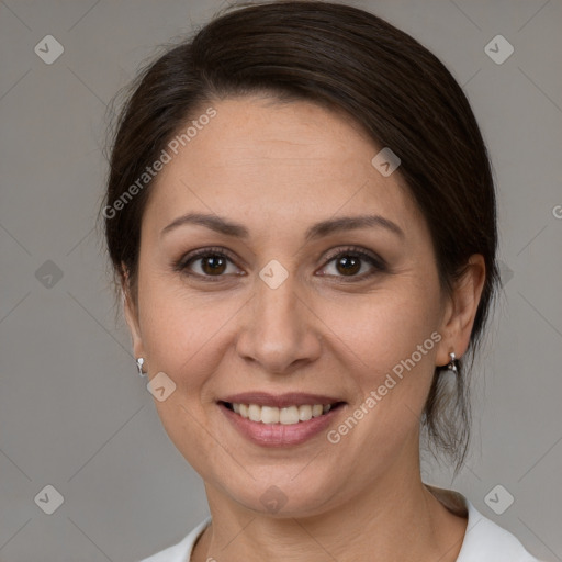 Joyful white adult female with medium  brown hair and brown eyes