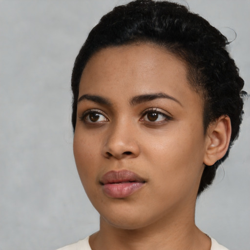 Joyful latino young-adult female with short  black hair and brown eyes