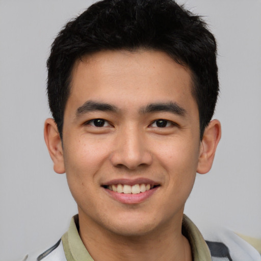 Joyful white young-adult male with short  black hair and brown eyes