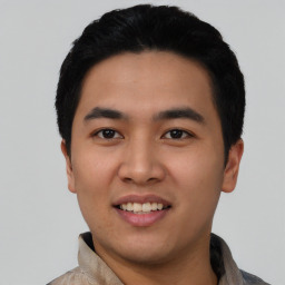 Joyful asian young-adult male with short  black hair and brown eyes