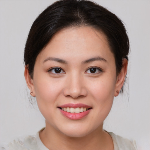 Joyful asian young-adult female with medium  brown hair and brown eyes